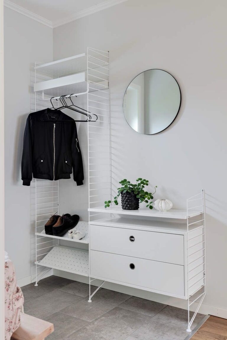 Hallway/Entry with string shelf system and jacket hanging and round mirror
