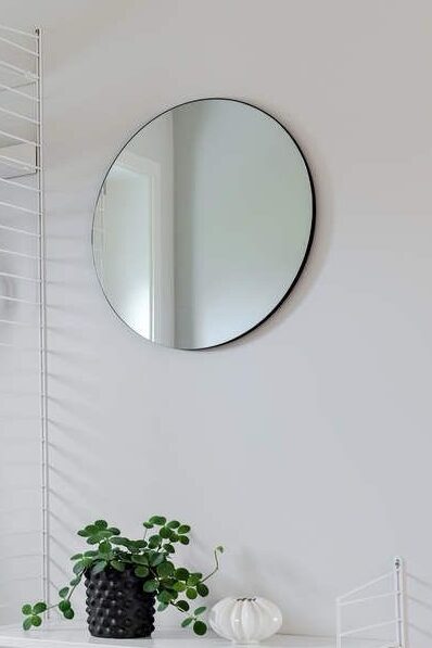 Hallway/Entry with string shelf system and jacket hanging and round mirror